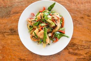 Thai food stir fried fish with pepper chili and herb on white plate - Tilapia fish cooked food photo