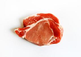 Top view of fresh sliced pork, meat or beef isolated on white background. Flat lay of Uncooked food. Freshness piece of steak prepare for grill or fried. photo