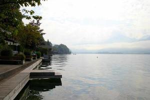 Travel to Sankt-Wolfgang, Austria. The view on the lake Wolfgangsee near to mountains in the cloudy weather. photo