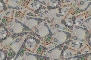 50 UAE dirhams bills lies in big pile. Rich life conceptual background photo