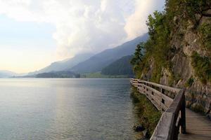 Travel to Sankt-Wolfgang, Austria. The road near to lake with the mountains on the background in the sunny day. photo