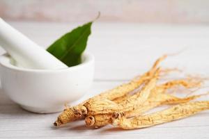 Ginseng roots and green leaf, healthy food. photo