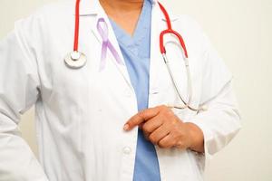 Asian woman doctor with purple ribbon, World Pancreatic Cancer day or World Alzheimer day. photo