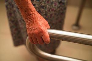 Asian elderly old woman patient use toilet support rail in bathroom, handrail safety grab bar, security in nursing hospital. photo