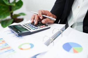 Business woman working and analysis with statistic graph in office. photo