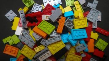 Plastic toy block on a black background photo