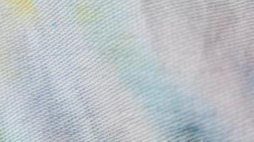 white cloth texture with yellow and blue patterns as background photo