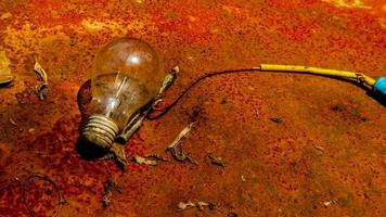 Light bulb on rusty zinc as a background photo