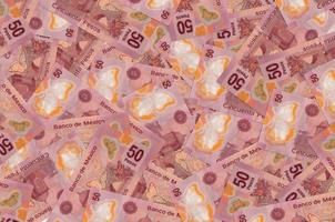 50 mexican pesos bills lies in big pile. Rich life conceptual background photo