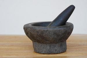 Old granite stone mortar and pestle. Concept, kitchen utensils .Thai cooking tool, use to  pound chili paste or curry paste. photo