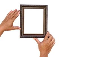 Hands hold photo frame, isolated on white background. Copy space for adding text or photos. Concept, Proud, memories and nostalgia. Exhibition, art gallery. Photography.