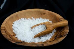 many salt crystals on olive wood photo