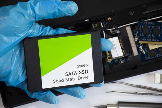 Technician installing ssd drive in old computer, upgrading computer photo