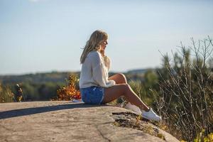 aerial view on girl stays on rock or concrete ruined structure photo