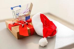 a huge gift with a red ribbon and a shopping cart photo