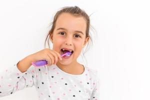 little girl shows a tooth baby toothbrush photo