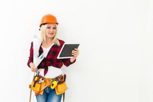 working woman in helmet with tablet isolated on white photo