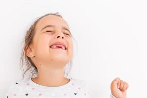 Little girl first tooth missing on a white background photo