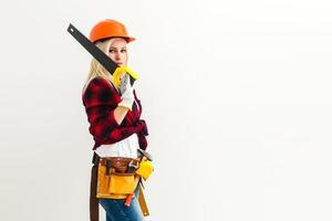 working woman in helmet with a saw isolated on white background. Female in male work. Renovation concept photo