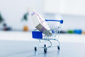 small gifts in the shopping cart on the beautiful blue background
