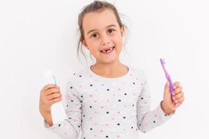 little girl shows a tooth baby toothbrush photo