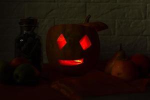 carved pumpkin for halloween lies on a table at home photo