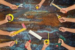 variety of tools for a constructions worker on the grunge white wooden background photo