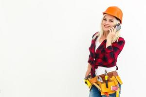 Attractive blonde business woman working as an architect on a building construction site photo