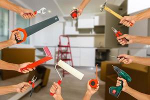 Hands with construction tools. House Renovation background. photo