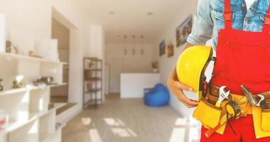 Builder handyman with construction tools. House renovation background. photo