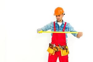 Construction worker pulling a rope. Full length studio shot isolated on white. photo