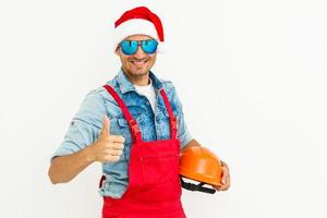 Worker in santa's hat. Isolated on a white background. photo