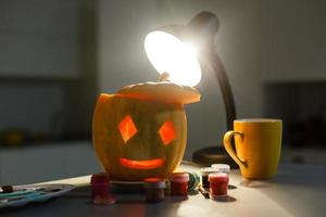 holidays, halloween, decoration and people concept - close up of pumpkins at home photo