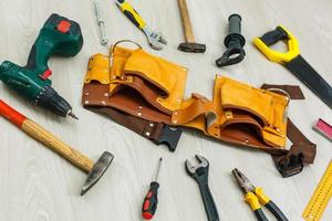 Assorted work tools on wood photo