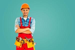 male construction worker over on turquoise background photo