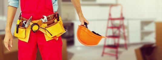 Handyman with a tool belt. House renovation service photo