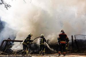 Firefighters in action, fire hoses photo