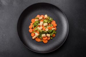 A mixture of vegetables carrots, small heads of corn, asparagus beans steamed photo