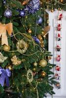 Beautiful Christmas tree with garlands, balls and toys photo