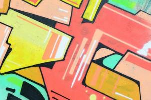 Background image with a colored graffiti pattern, which is applied to the concrete wall with aerosol paints. A lot of contours and fragments filled with paint, forming an interesting composition photo