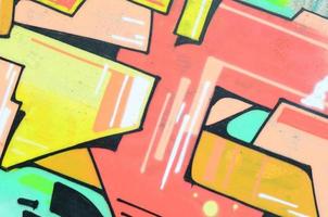 Background image with a colored graffiti pattern, which is applied to the concrete wall with aerosol paints. A lot of contours and fragments filled with paint, forming an interesting composition photo