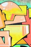 Background image with a colored graffiti pattern, which is applied to the concrete wall with aerosol paints. A lot of contours and fragments filled with paint, forming an interesting composition photo