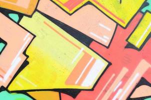 Background image with a colored graffiti pattern, which is applied to the concrete wall with aerosol paints. A lot of contours and fragments filled with paint, forming an interesting composition photo