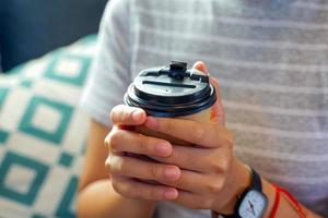 Asian woman enjoying coffee at home, the concept of resting after work, relaxing, cozy corner, peaceful corner. Soft and selective focus. photo