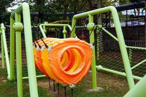 un conjunto de equipos de escalada en el patio de recreo al aire libre con una red de escalada y un aro. esto ayudará a mejorar el desarrollo físico y mental de los niños. foto