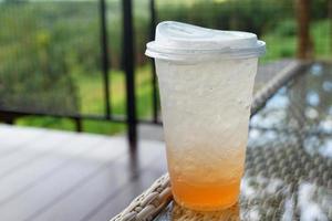 Glass of yuzu soda on a table background. Drink menu in the coffee shop. Soft and selective focus. photo