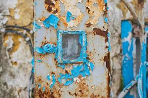 Layers of old paint peel off the wall of a house, selective focus, ideas for a background or wallpaper, renovation of old houses photo