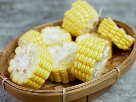 chopped raw corn on a bamboo plate photo