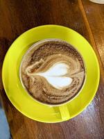 Cup of coffee latte on a wooden table. top view photo