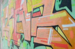 Background image with a colored graffiti pattern, which is applied to the concrete wall with aerosol paints. A lot of contours and fragments filled with paint, forming an interesting composition photo